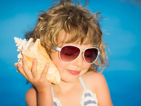 Child listening to a shell