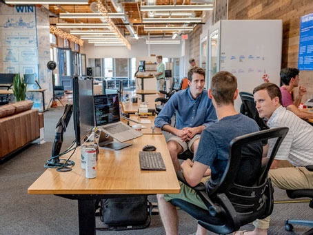 3 people meeting in an office