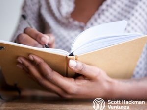 Person making notes in a notebook